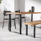 Dining table and bench with black metal legs in a modern setting