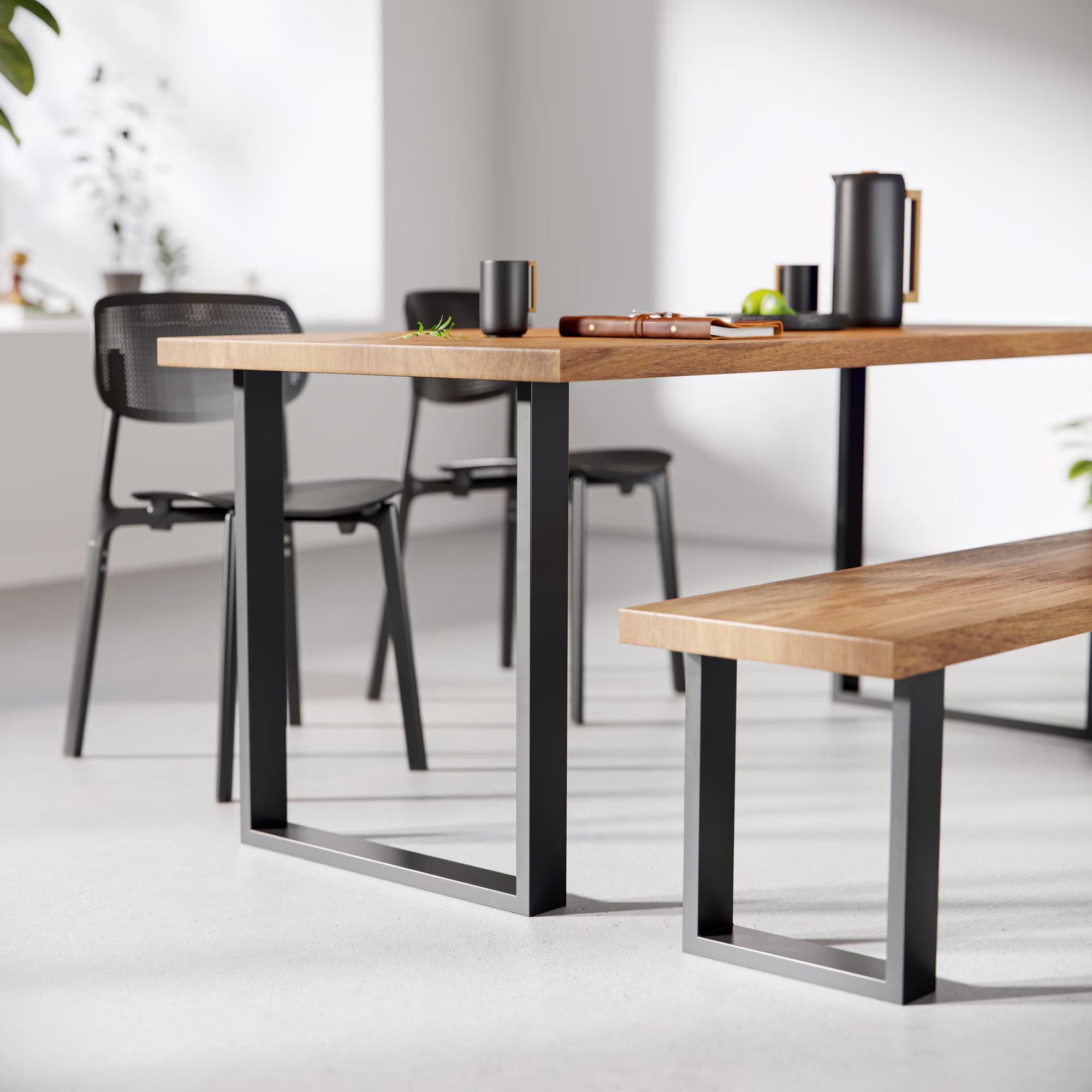 Dining table and bench with black metal legs in a modern setting