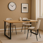 Dining room with a wooden table and four chairs against a beige wall.